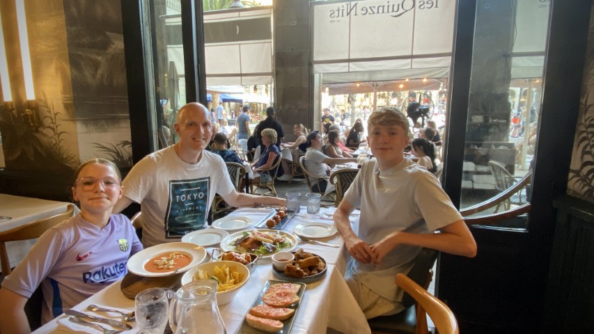 Rick and his children having tapas in Barcelona